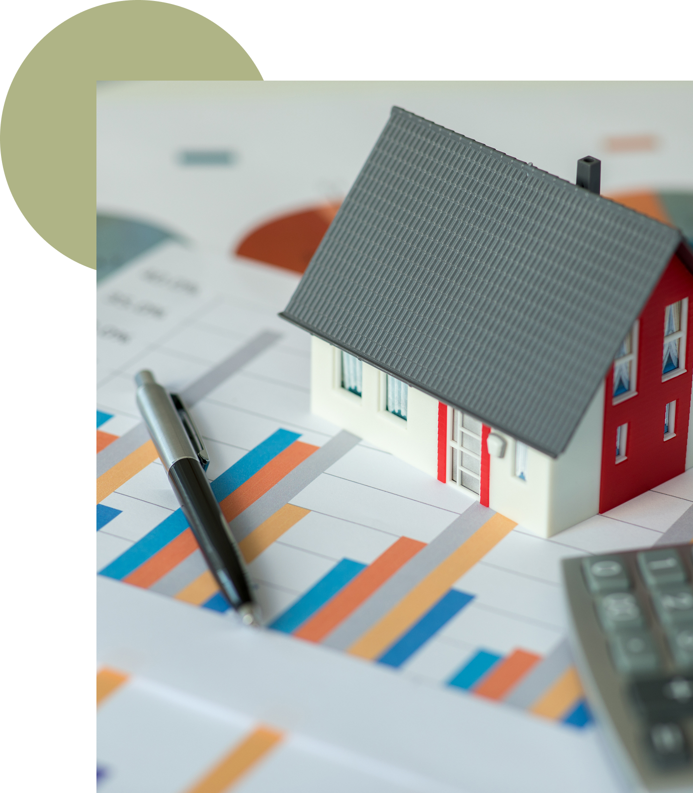 Model house on financial charts with pen.